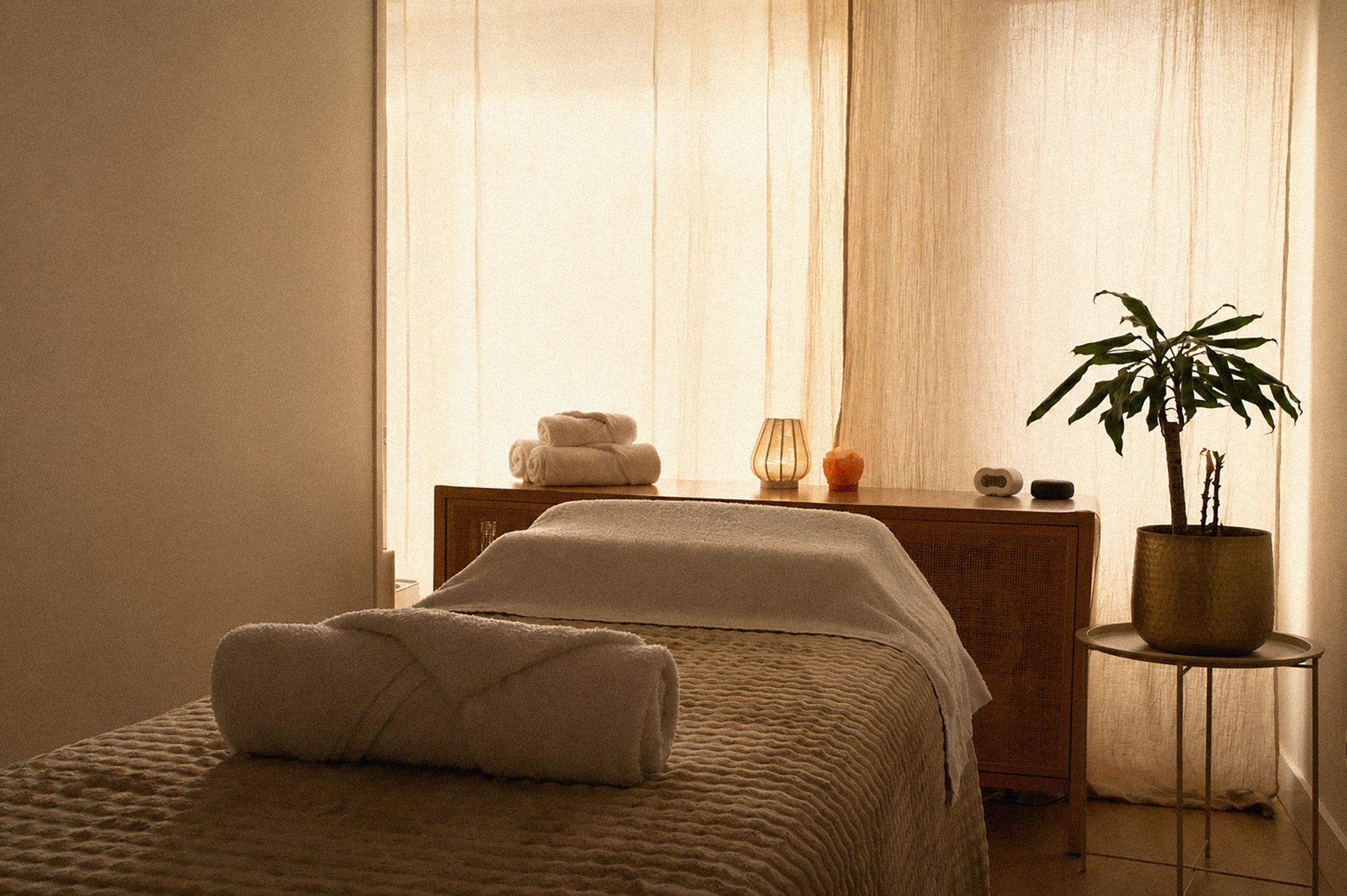 A serene spa moment draped in soft fabric and warm light
